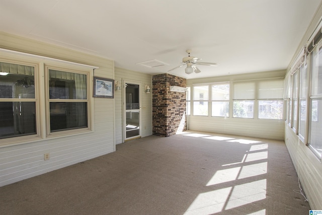 unfurnished sunroom featuring a ceiling fan