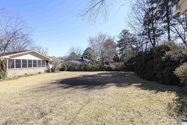 view of yard featuring a sunroom