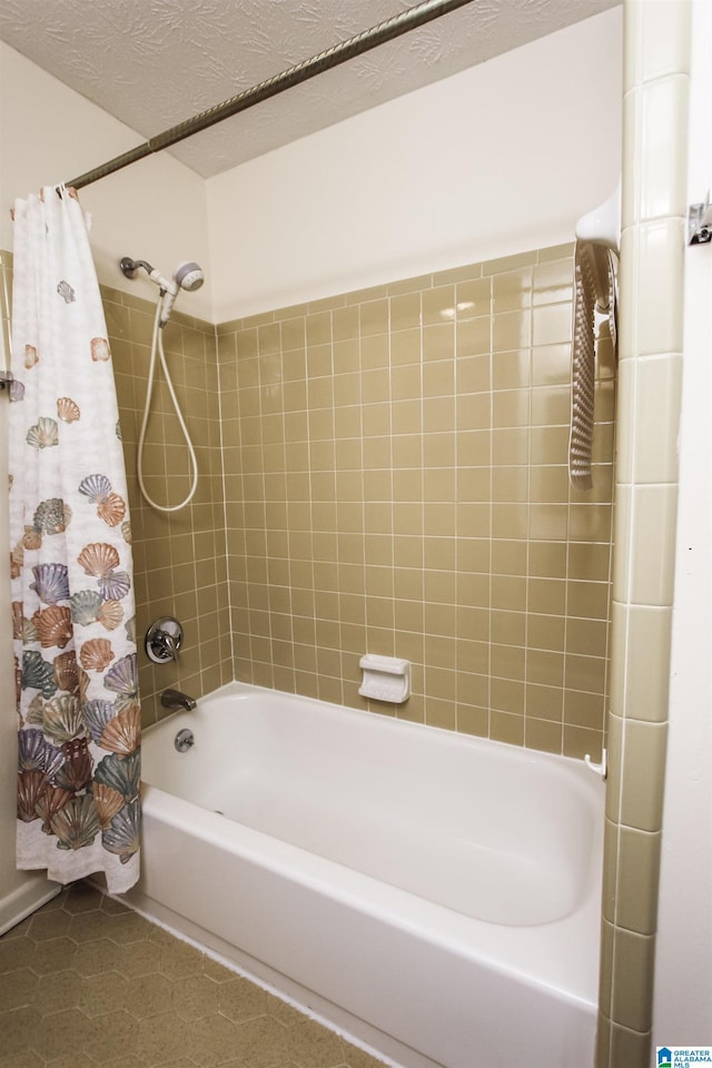 bathroom featuring shower / tub combo with curtain, a textured ceiling, and tile patterned floors