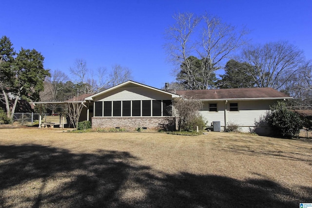 rear view of house with crawl space, cooling unit, and a sunroom