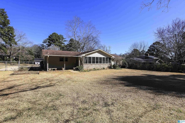 back of property featuring fence and a lawn