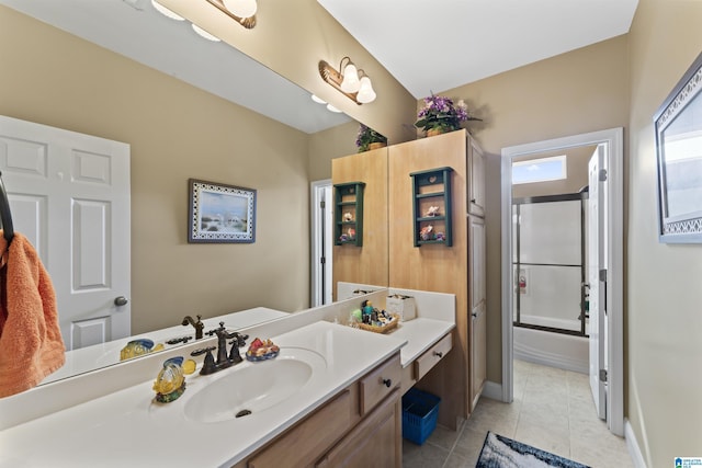 full bathroom featuring baseboards, vanity, enclosed tub / shower combo, and tile patterned floors