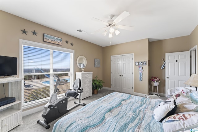 carpeted bedroom featuring visible vents, baseboards, ceiling fan, and a closet