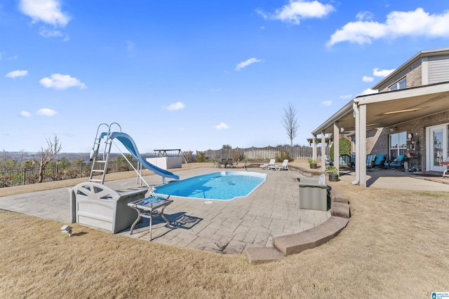 view of pool featuring a fenced in pool, a water slide, a patio area, and a fenced backyard