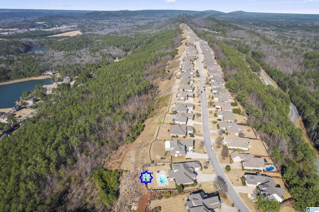 bird's eye view featuring a water view, a residential view, and a view of trees