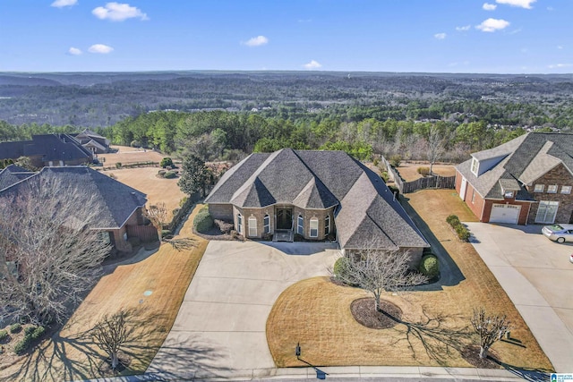 birds eye view of property with a view of trees