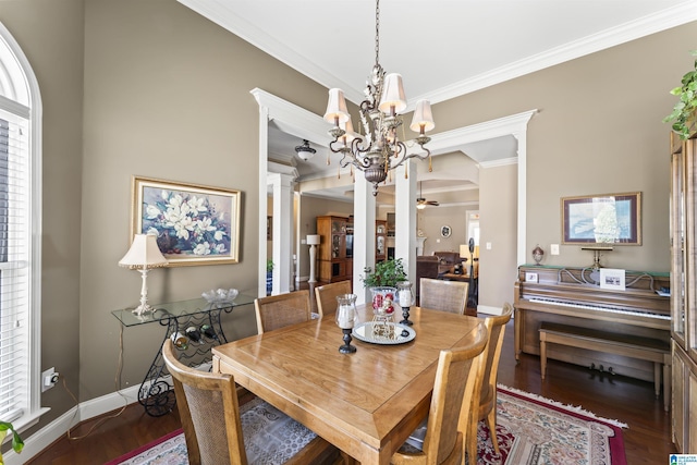 dining area with crown molding, decorative columns, wood finished floors, baseboards, and ceiling fan with notable chandelier