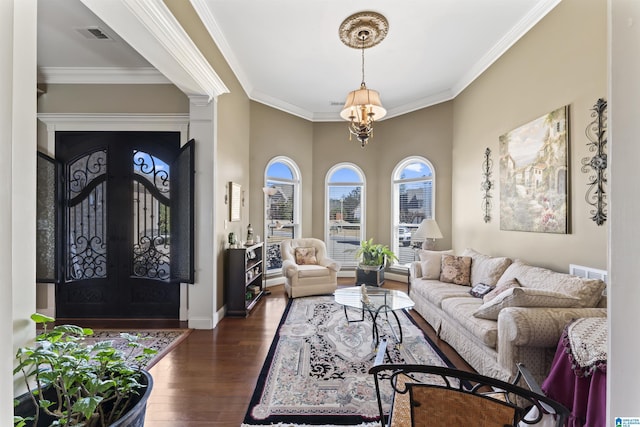 interior space with a chandelier, visible vents, french doors, dark wood finished floors, and crown molding