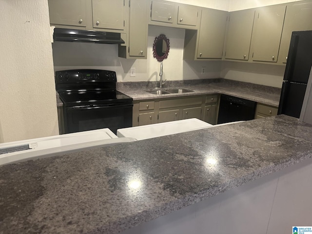 kitchen featuring dark countertops, a sink, under cabinet range hood, and black appliances