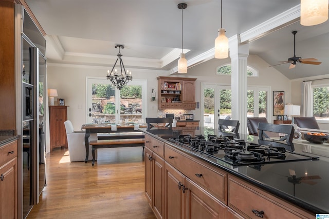 kitchen featuring dark countertops, black gas cooktop, a tray ceiling, light wood-type flooring, and open shelves