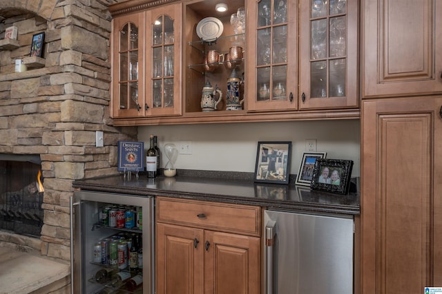 bar with a bar, fridge, and wine cooler