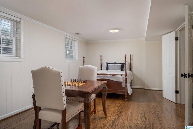 bedroom featuring baseboards, visible vents, and wood finished floors