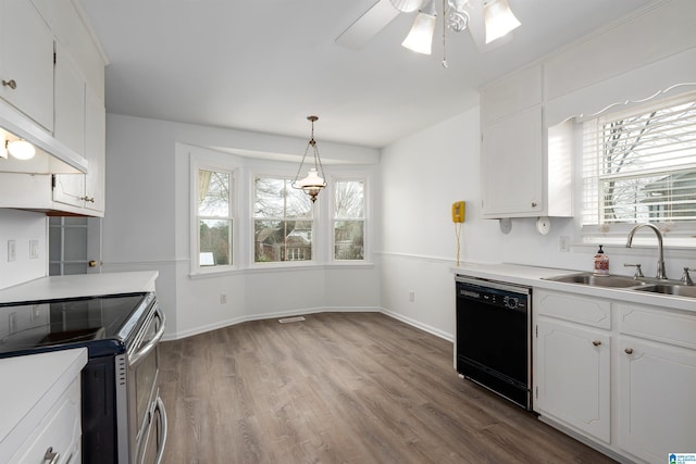 kitchen featuring black dishwasher, stainless steel range with electric cooktop, a sink, and white cabinets