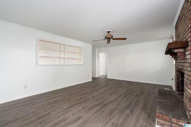 unfurnished living room featuring dark wood-style floors, a fireplace, baseboards, and ornamental molding