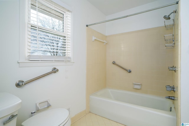 bathroom featuring bathtub / shower combination, toilet, and tile patterned floors