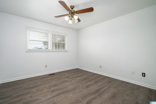 unfurnished room featuring ceiling fan, baseboards, visible vents, and dark wood finished floors