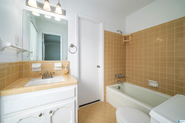 bathroom featuring tasteful backsplash, bathing tub / shower combination, vanity, and toilet