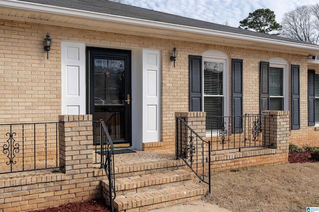 doorway to property featuring brick siding