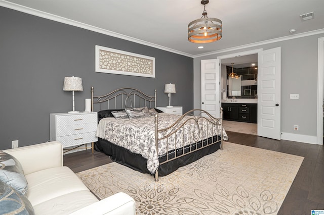 bedroom featuring a notable chandelier, dark wood-type flooring, ornamental molding, a sink, and baseboards