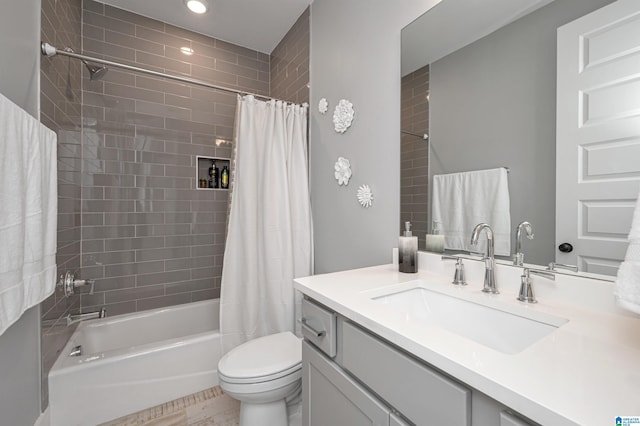 full bath featuring toilet, shower / tub combo with curtain, and vanity