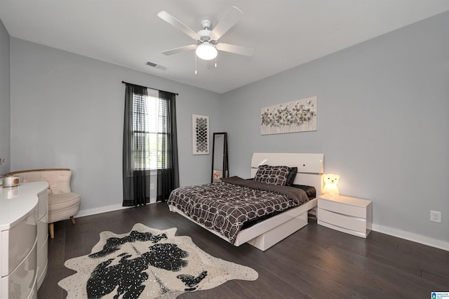 bedroom featuring baseboards, visible vents, ceiling fan, and wood finished floors