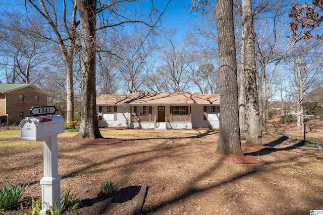 single story home with a porch and brick siding