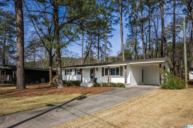 ranch-style house featuring an attached carport and driveway