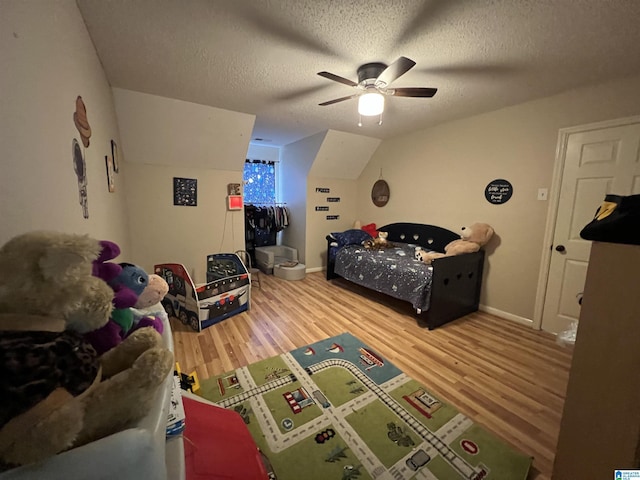 bedroom featuring a textured ceiling, a ceiling fan, and wood finished floors