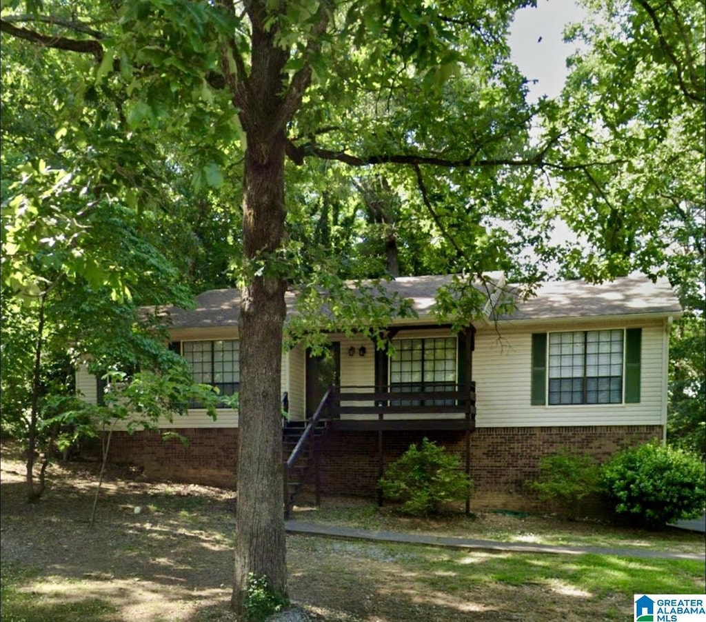 ranch-style home with brick siding and stairway