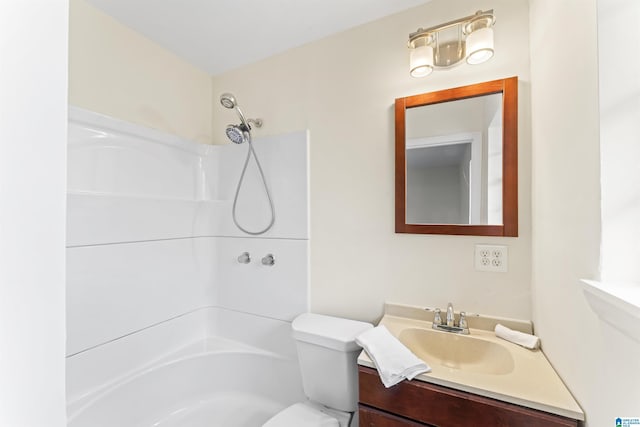 full bath with bathtub / shower combination, vanity, and toilet