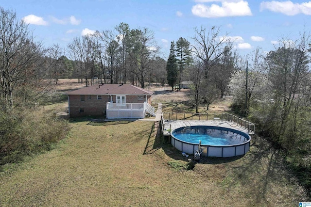 pool featuring a lawn and fence