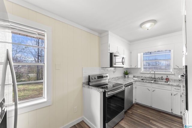 kitchen with a healthy amount of sunlight, appliances with stainless steel finishes, and a sink