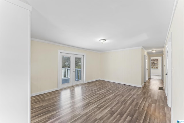 spare room featuring baseboards, french doors, wood finished floors, and crown molding