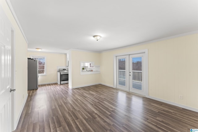 unfurnished living room with crown molding, french doors, dark wood-type flooring, and baseboards