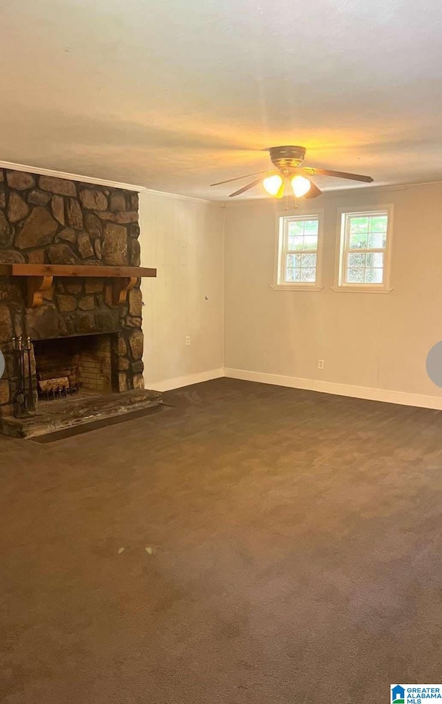 unfurnished living room featuring dark colored carpet, a fireplace, baseboards, and ceiling fan