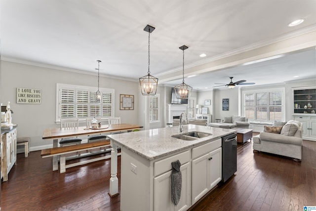 kitchen with a sink, open floor plan, ornamental molding, dark wood-style floors, and dishwasher