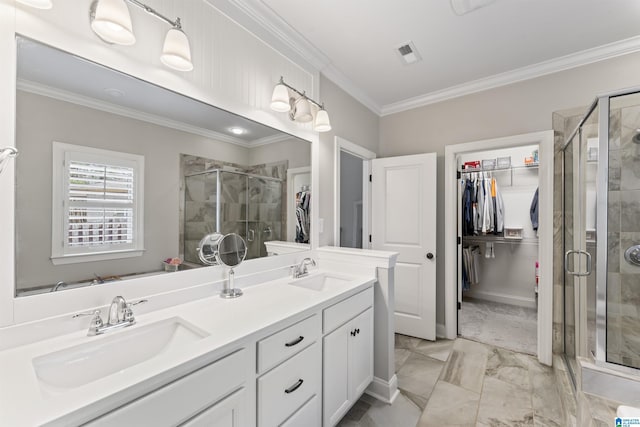 bathroom featuring crown molding, a spacious closet, visible vents, and a sink