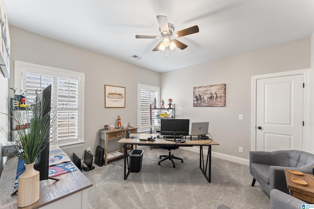 carpeted office with a ceiling fan, visible vents, and baseboards