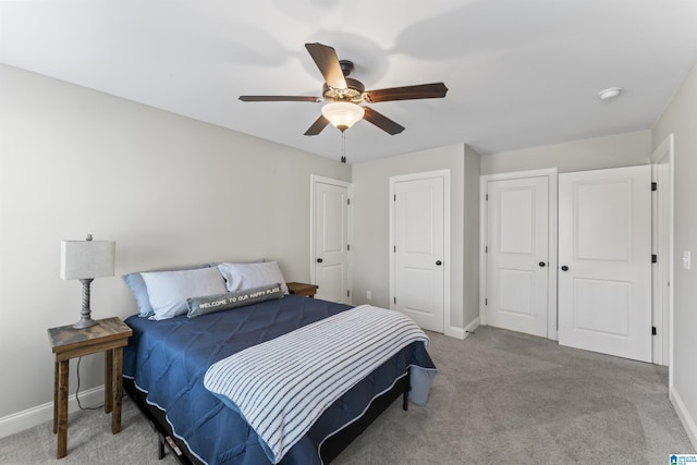 carpeted bedroom with baseboards and a ceiling fan