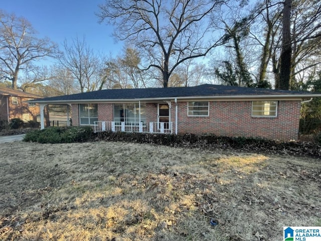 ranch-style home with covered porch and brick siding