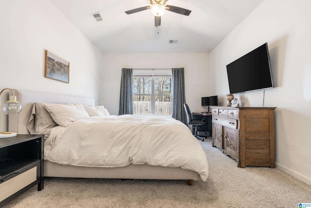 bedroom featuring a ceiling fan, light colored carpet, visible vents, and baseboards