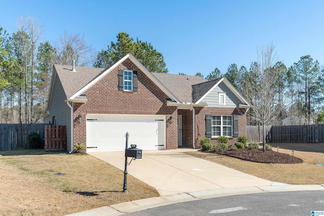 traditional-style house with a garage, concrete driveway, brick siding, and fence