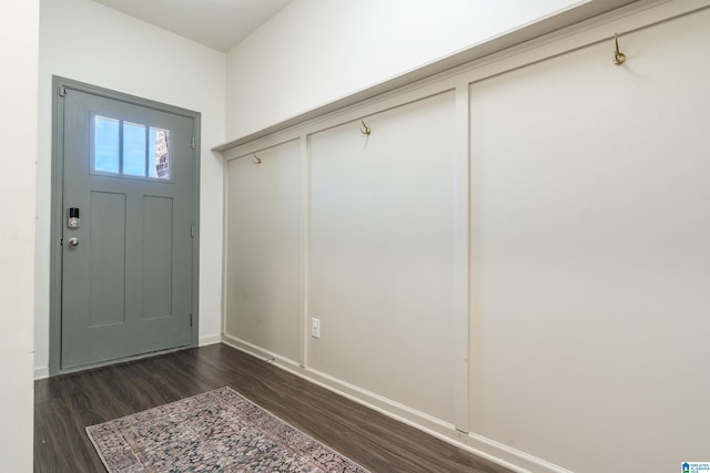 mudroom with dark wood finished floors and baseboards