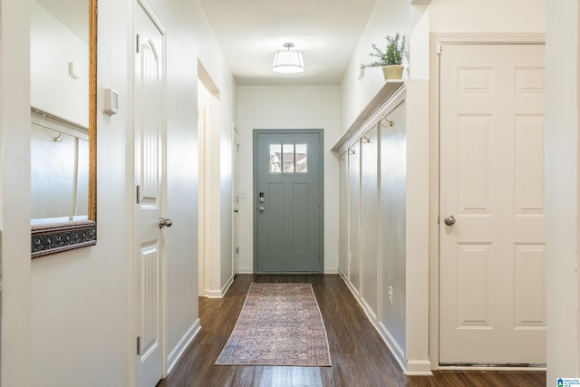 entryway with dark wood-style floors and baseboards