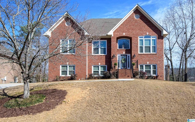 bi-level home featuring brick siding