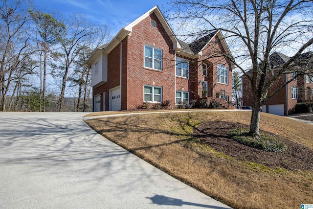 view of front facade featuring a garage, brick siding, and driveway