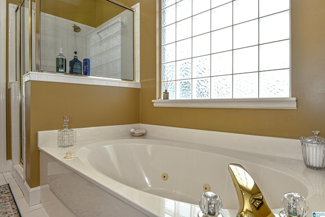 full bathroom with a whirlpool tub, tile patterned floors, a shower stall, and a healthy amount of sunlight