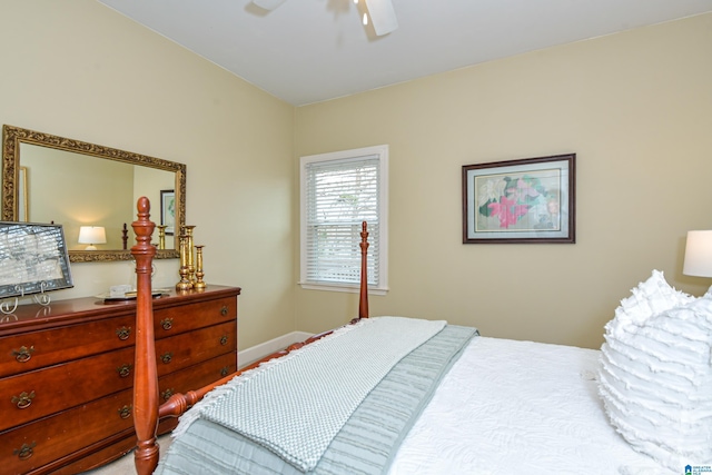 bedroom with a ceiling fan and baseboards