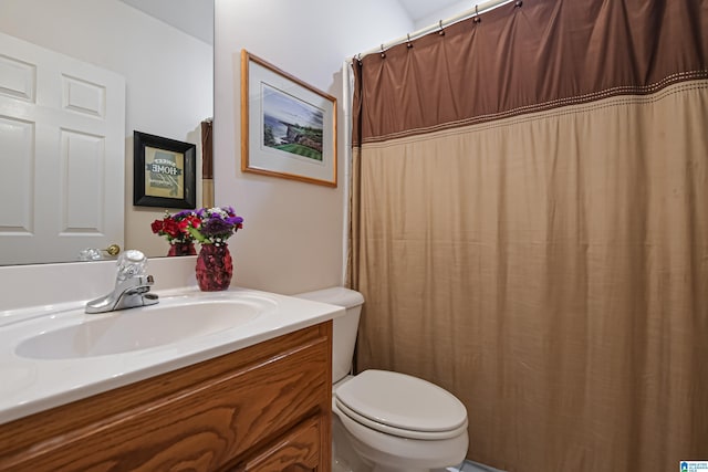 full bath featuring vanity and toilet