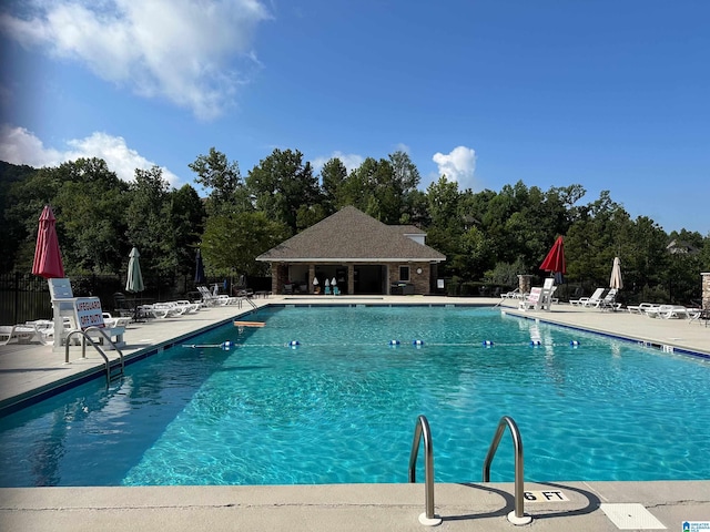 community pool featuring a patio and fence